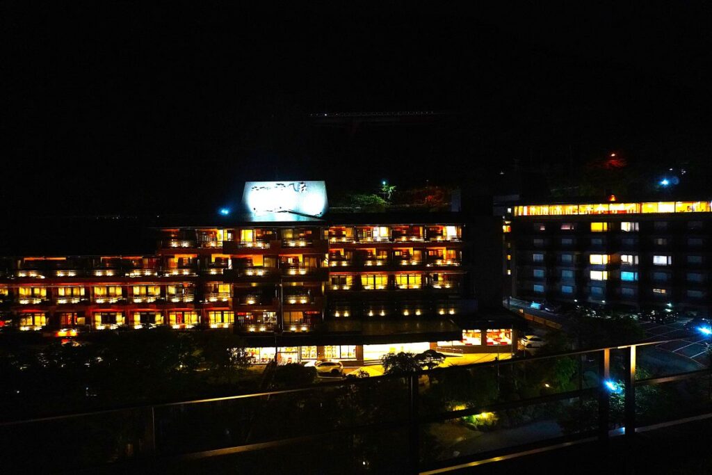 Rooftop terrace with illuminated foot baths at Hotel Okada in Hakone at night