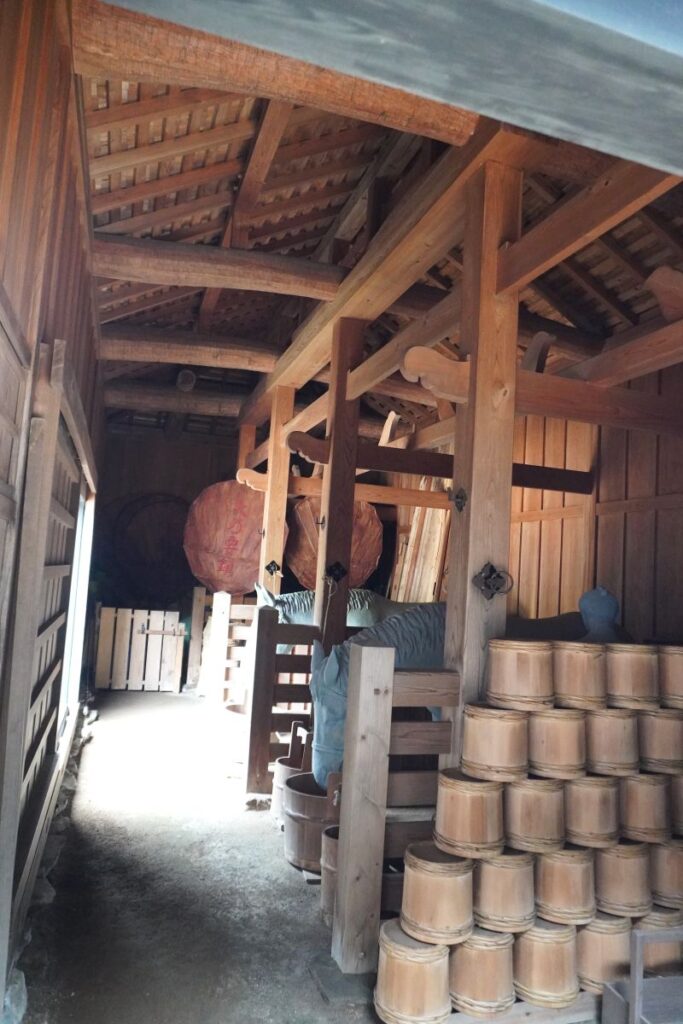 Reconstructed stable at Hakone Checkpoint showing horses and Edo-period equipment.