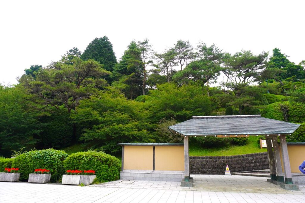 Entrance gate to Onshi Hakone Park surrounded by lush greenery
