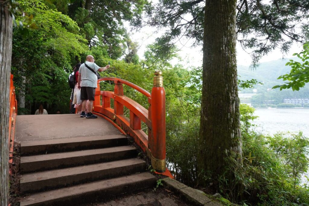 Red bridge and lakeside path near Hakone Shrine