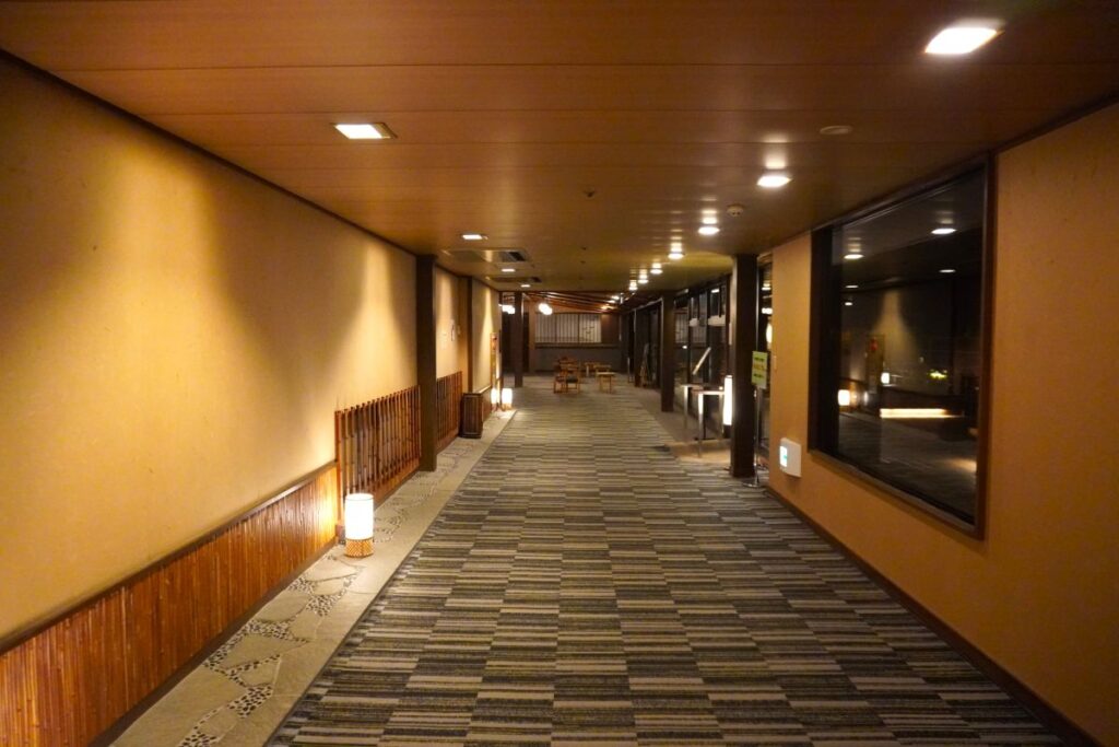 Quiet hallway leading to the rooftop foot bath and relaxation area at Hotel Okada