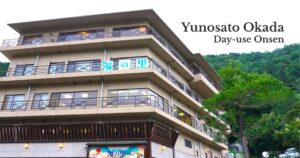 Exterior view of Yunosato Okada day-use onsen in Hakone-Yumoto surrounded by green mountains.