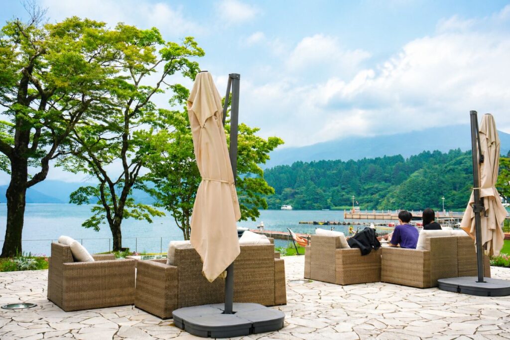Outdoor lounge sofas overlooking Lake Ashi at Hakone Hotel